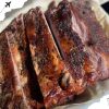 Succulent grilled steak with seasoned crust, cooked to perfection, served with a hint of spices and charred grill marks, ideal for meat lovers and barbecue enthusiasts seeking top-quality seafood dining.