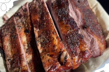 Succulent grilled steak with seasoned crust, cooked to perfection, served with a hint of spices and charred grill marks, ideal for meat lovers and barbecue enthusiasts seeking top-quality seafood dining.
