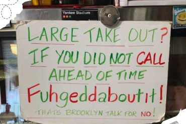 Large takeout question sign at Brooklyn restaurant with playful handwritten message and colorful text.