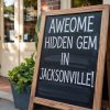 Hidden gem in Jacksonville chalkboard sign outside a store, inviting visitors to explore local attractions and unique destinations in Jacksonville.