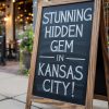 Chalkboard sign outside restaurant in Kansas City highlighting hidden gems and unique attractions for visitors. Perfect for travel inspiration and exploring off-the-beaten-path spots.