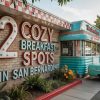 2. Retro diner with a neon sign advertising 24 cozy breakfast spots in San Bernardino, featuring a classic turquoise and chrome exterior.