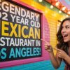 Colorful street art sign promoting a Mexican restaurant in Los Angeles, featuring vibrant lettering and a cheerful woman pointing excitedly, perfect for travel and dining destinations.