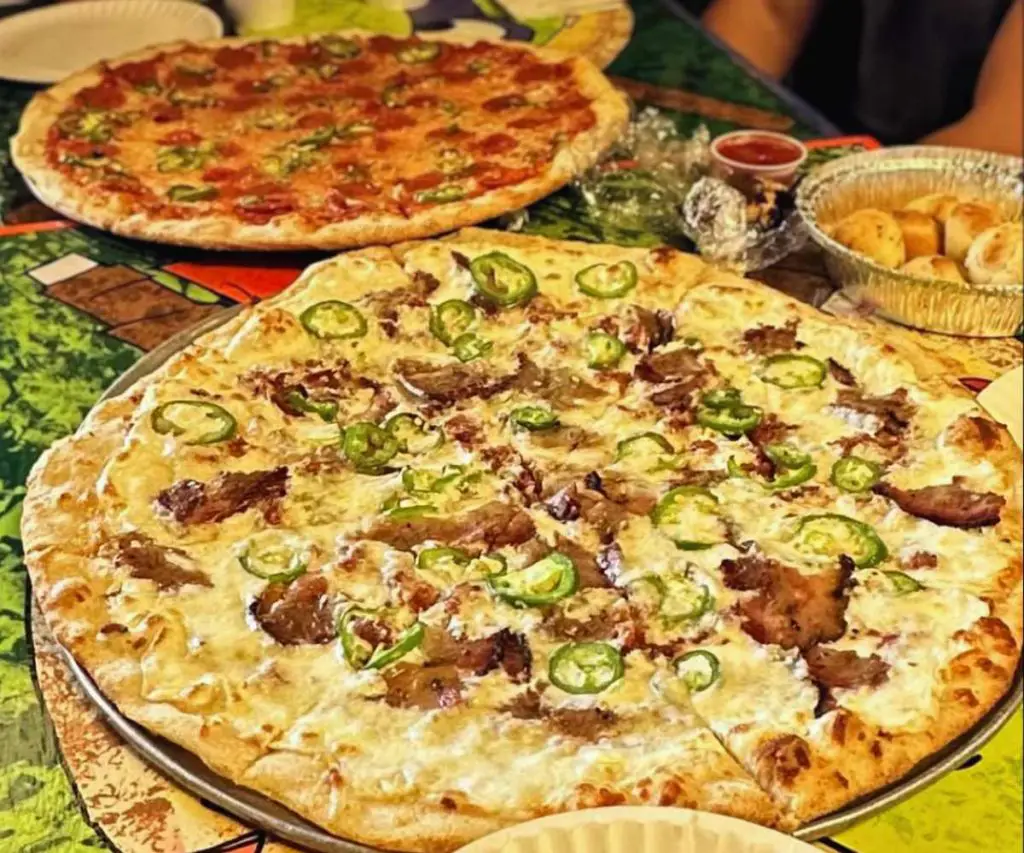 Cheese and pepperoni pizza with jalapenos on top, American-style pizza with toppings, Italian favorite, served at a casual pizzeria, delicious cheesy pizza with spicy jalapenos, perfect for pizza lovers.
