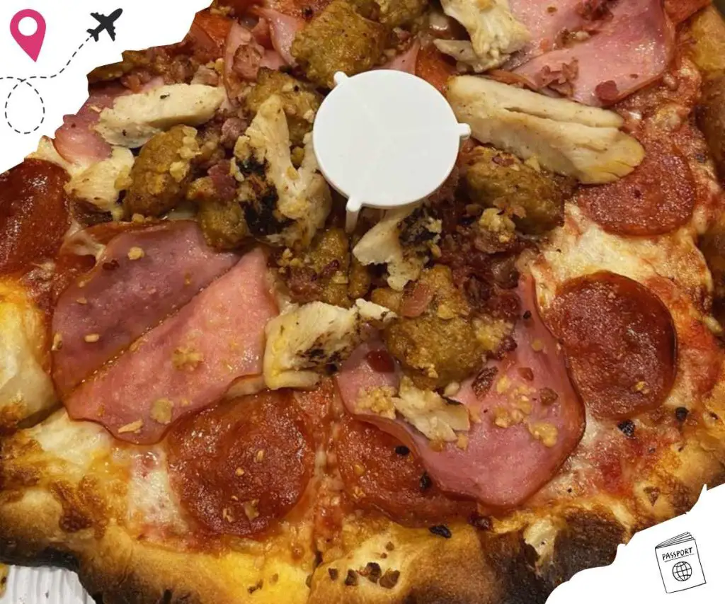 Sliced pepperoni and chicken pizza with toppings close-up, delicious authentic travel food, Italian cuisine, cheesy pizza with savory toppings, popular travel destination food, Go To Destinations image for travel and food enthusiasts.