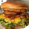 Savory bacon cheeseburger with lettuce and melted cheese, close-up macro photo.