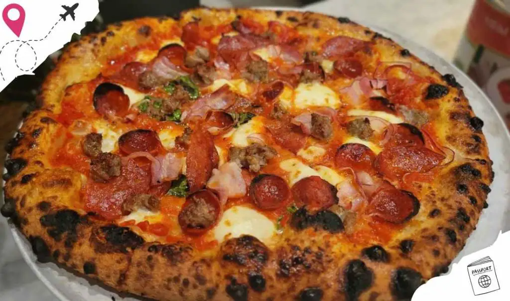 Delicious pepperoni and meat pizza with crispy crust, melted cheese, and fresh toppings, served hot, perfect for any pizza lover.
