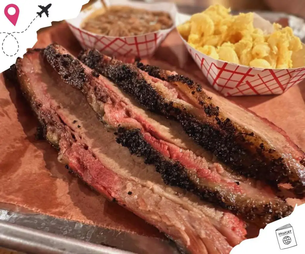 Smoked brisket with crispy bark served with mashed potatoes and baked beans, classic barbecue meal, delicious smoked meats, comfort food, southern cuisine, hearty barbecue platter, meat lovers' favorite, Go To Destinations.