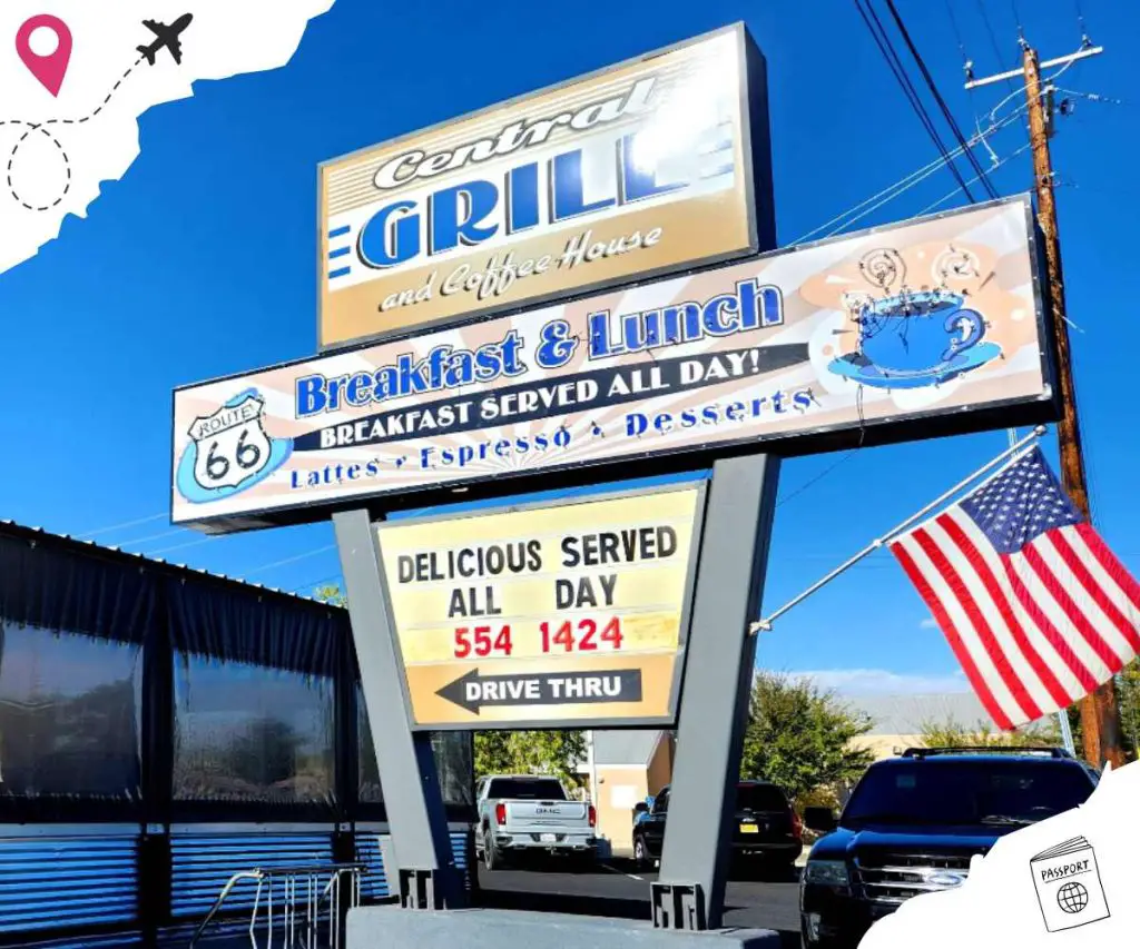 Route 66 diner sign promoting breakfast and lunch offerings with American flag and clear blue sky.