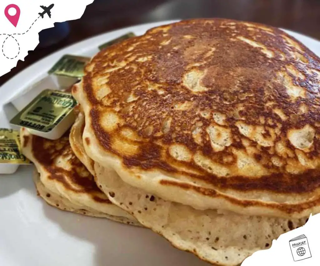Fluffy homemade pancakes with butter and syrup, delicious breakfast dish, classic American morning meal, stack of golden brown pancakes, sweet and satisfying comfort food.