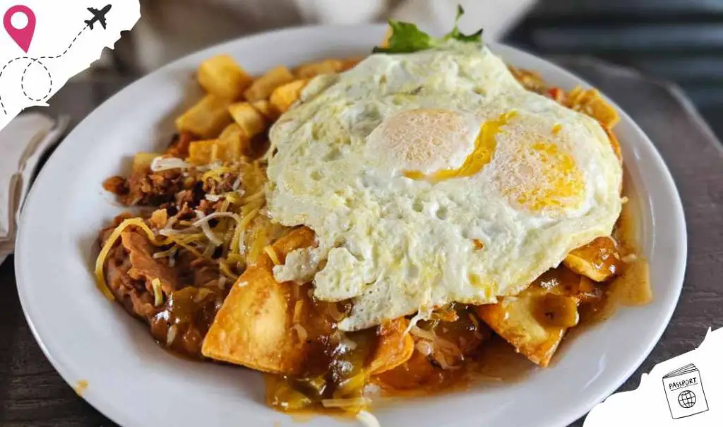 Savory breakfast dish featuring fried eggs on top of hearty hash with potatoes, vegetables, and crispy toppings, ideal for travelers seeking local cuisine experiences.