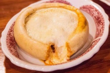 Crispy Mexican cheese-filled shrimp chipotle pepper tamale on a decorative plate.