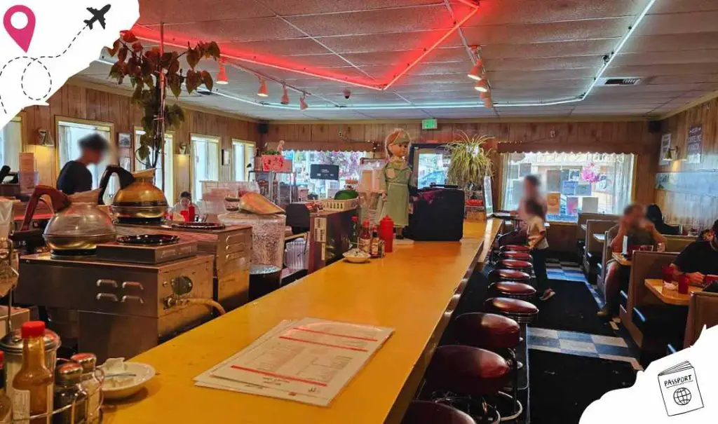Cozy American diner with wooden decor, a welcoming counter, and family-friendly seating, perfect for casual dining and travel destination experience.