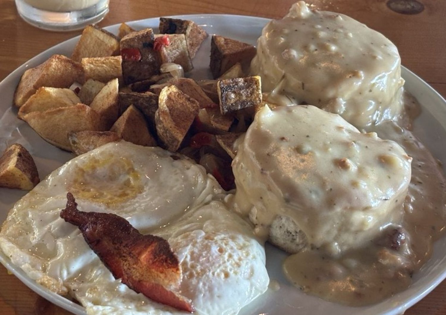Biscuits & Jalapeno Cheddar Gravy with eggs and home potatoes in Lovely Day Cafe located in Bedford, TX.