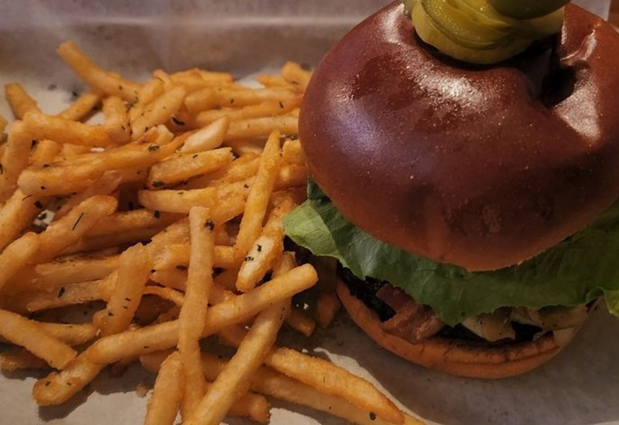 Burger with fries in The Rooster Tavern located in Scottsdale, Arizona
