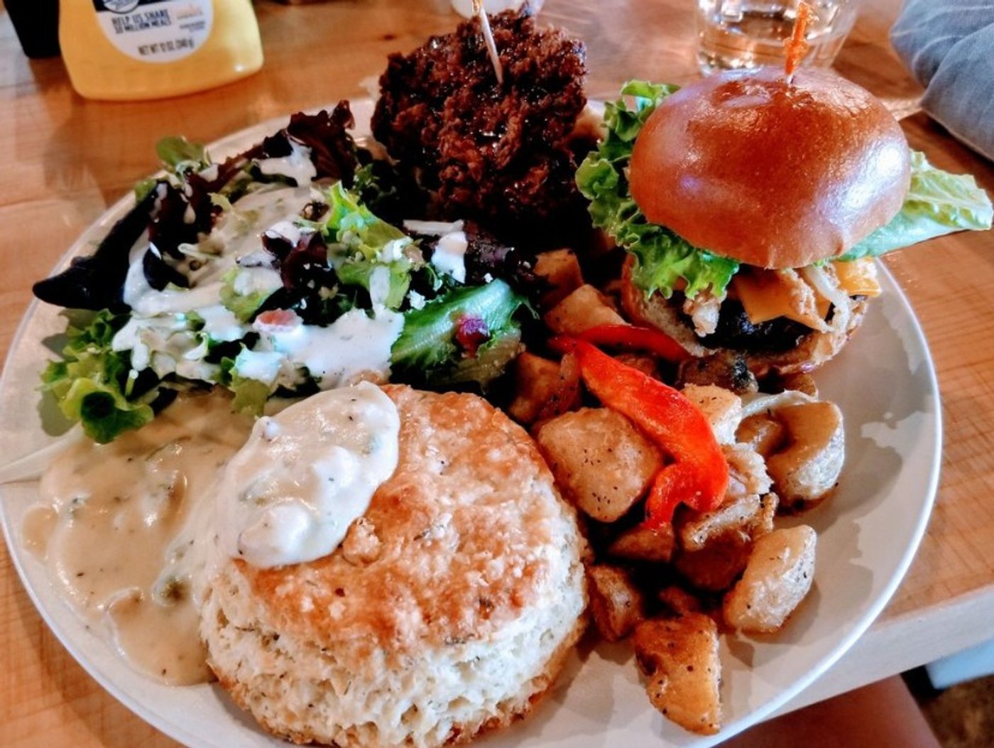 Cobb salad, fried chicken and waffle, wg burger, potatoes, biscuit and gravy in Lovely Day Cafe located in Bedford, TX.