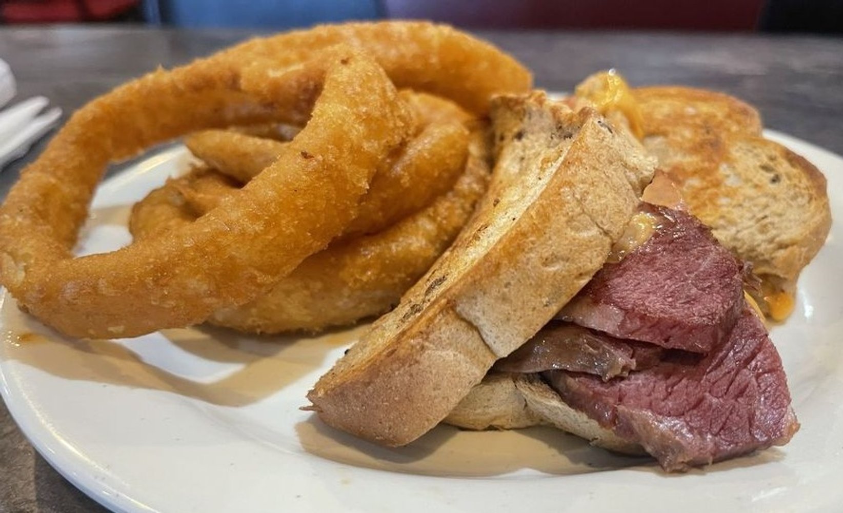 Corned Beef Reuben Sandwich Onion Rings at Mom & Pops located in Norfolk, Virginia