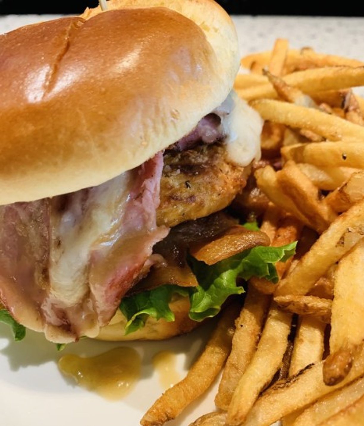 Ham - bacon - fried chicken sandwich at EnVie located in Lansing, MI.