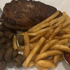 NY Strip with mushrooms and French fries in Henry Flach in West Allis, WI.