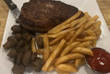 NY Strip with mushrooms and French fries in Henry Flach in West Allis, WI.