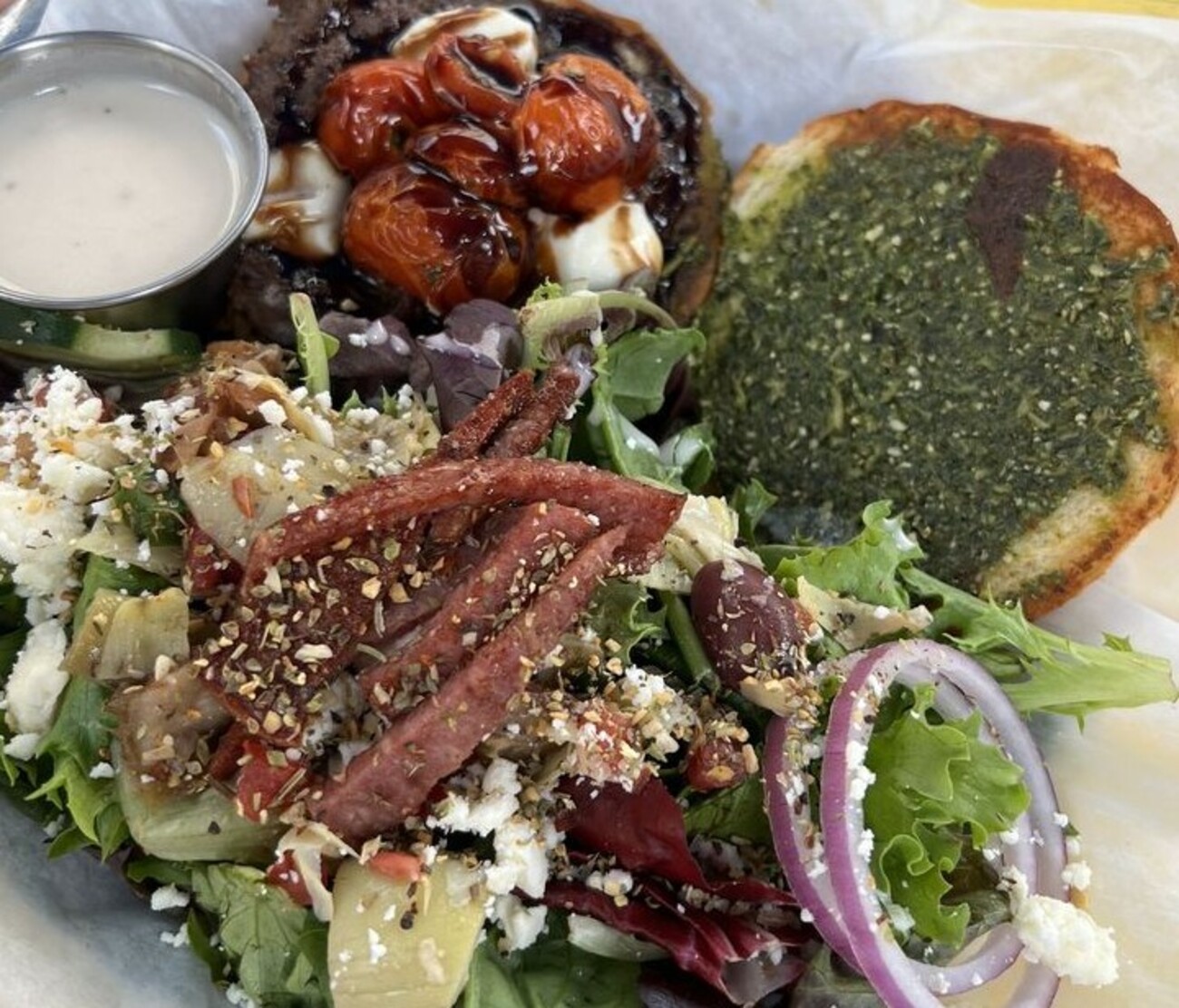 Napoli burger with a side of Athens salad at The Map Room located in Cedar Rapids, IA.