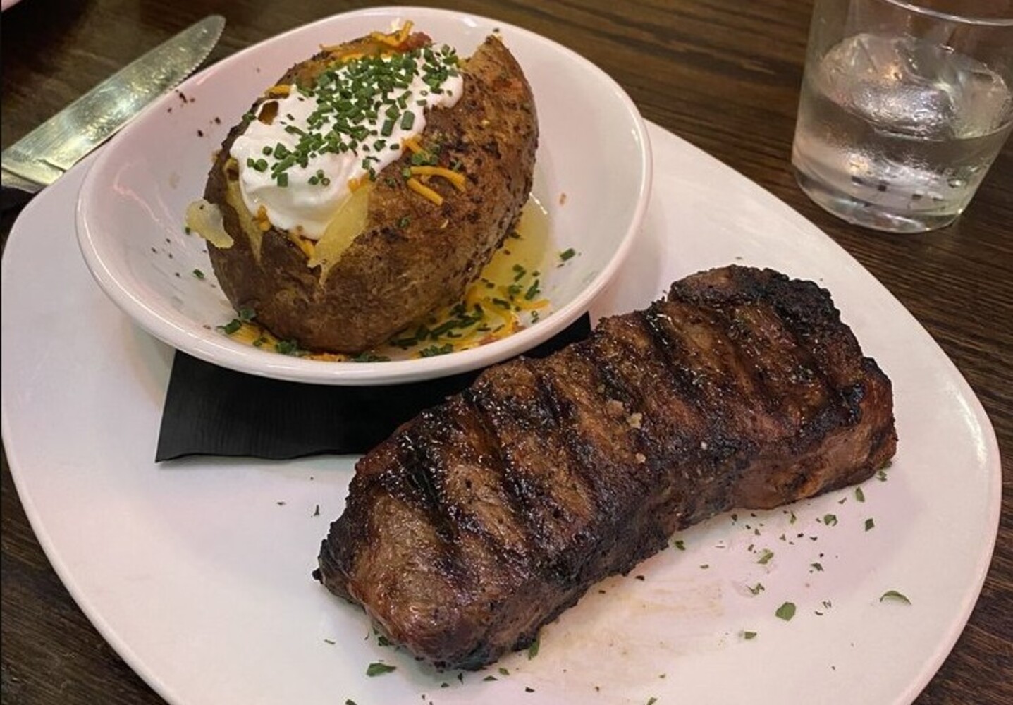 New York Strip with Loaded Baked Potato at Manning's Steaks and Spirits located in Lakewood,Colorado.