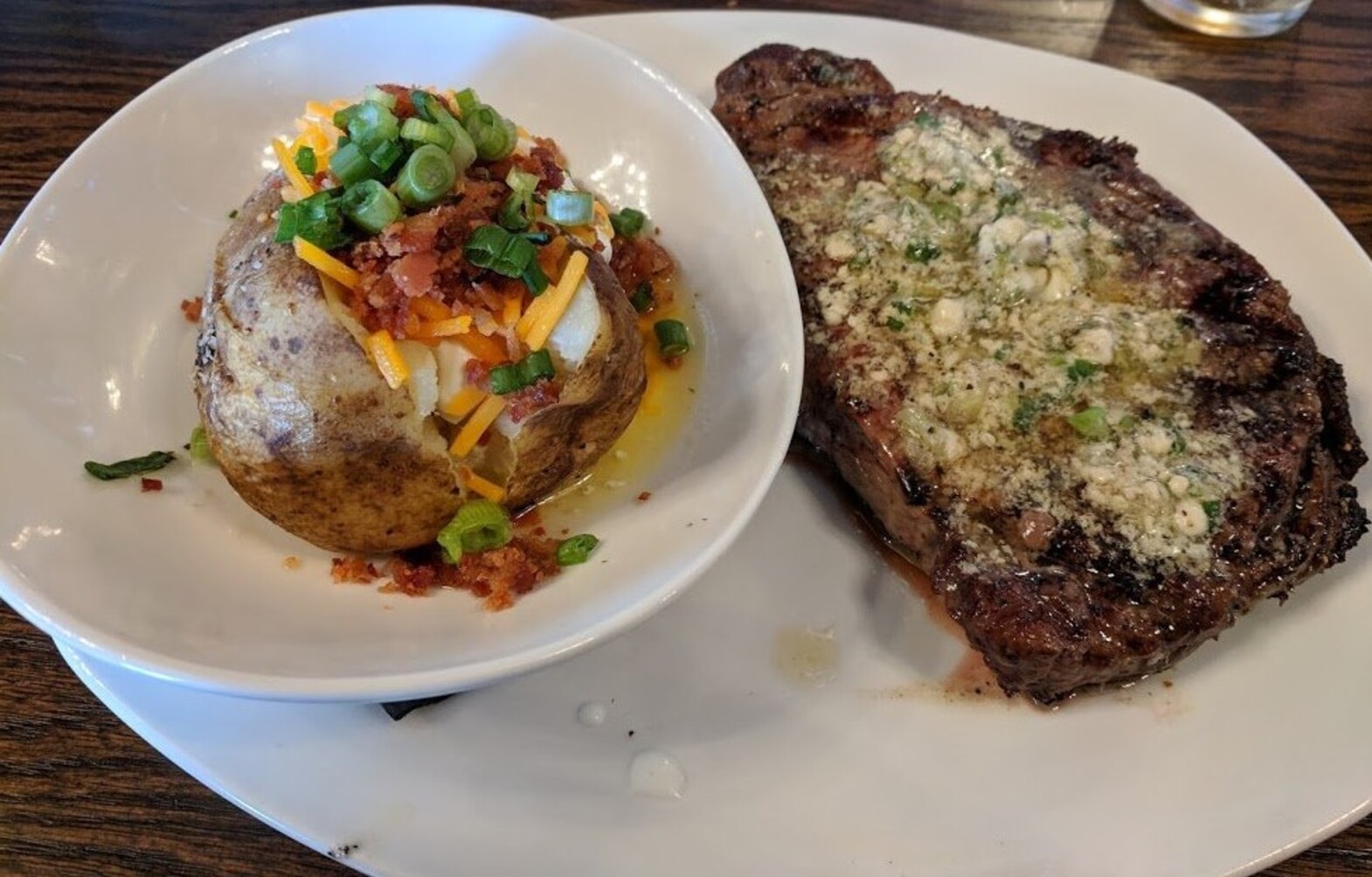 Rib Eye with Blue Cheese and Loaded Baked Potato at Manning's Steaks and Spirits located in Lakewood,Colorado.