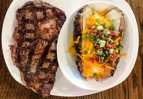 Ribeye with a loaded baked potato at Manning's Steaks and Spirits located in Lakewood,Colorado.
