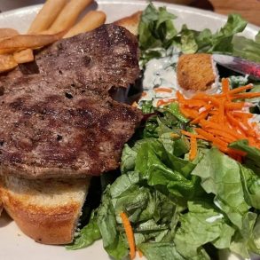 Tenderloin steak fries and salad in The Pumphouse Bar & Grill located in Bellevue, WA.