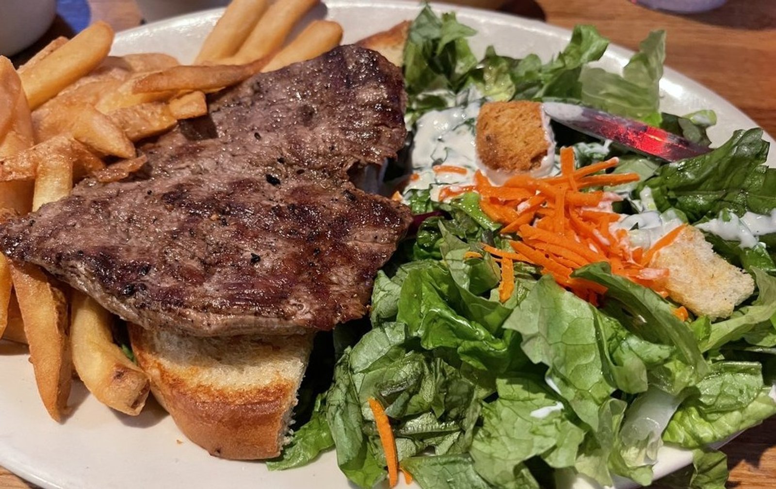 Tenderloin steak fries and salad in The Pumphouse Bar & Grill located in Bellevue, WA. 