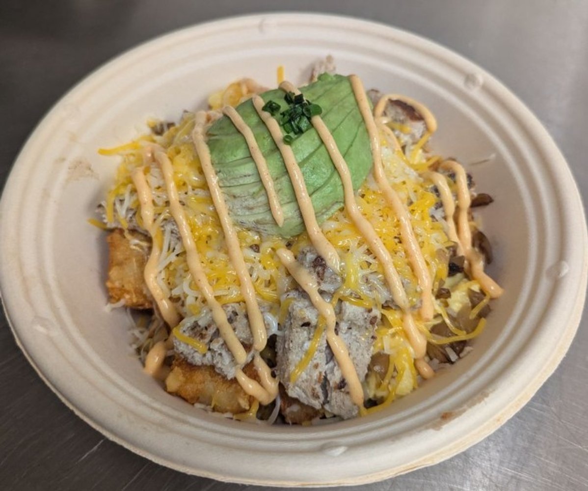 Turkey patty, melted cheese, scrambled egg, grilled onions, fresh avocado and mild club drizzle in The Bite Club in Santa Ana, CA.