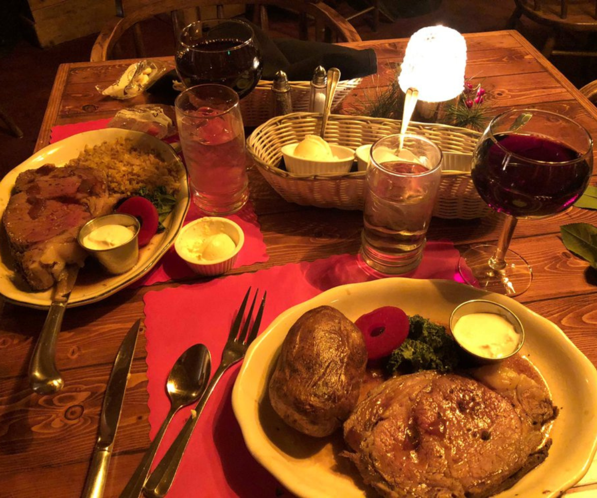 Prime rib platters served with sauce and wine.