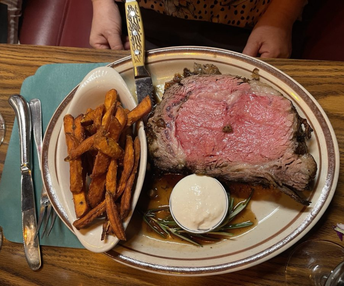 A perfect prime rib paired with fries and sauce.