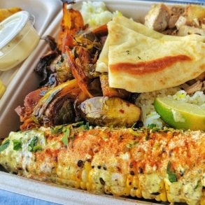 Chicken and street corn at Local Expedition Wood Fired Grill located in Alpharetta, GA.