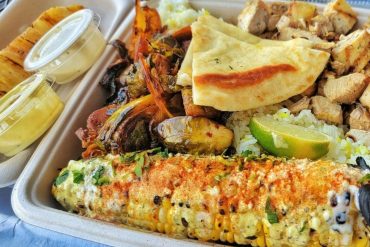 Chicken and street corn at Local Expedition Wood Fired Grill located in Alpharetta, GA.