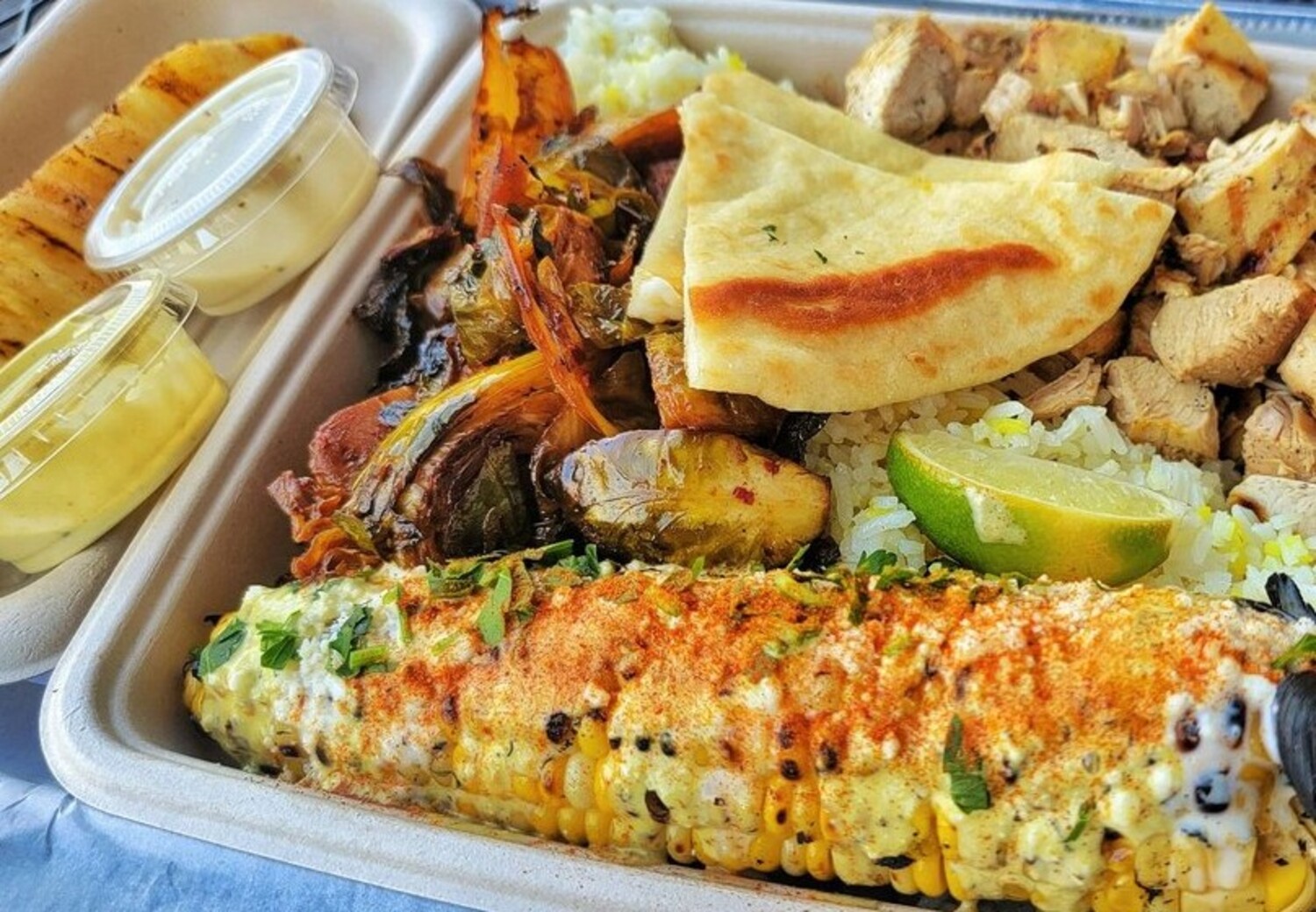 Chicken and street corn at Local Expedition Wood Fired Grill located in Alpharetta, GA. 