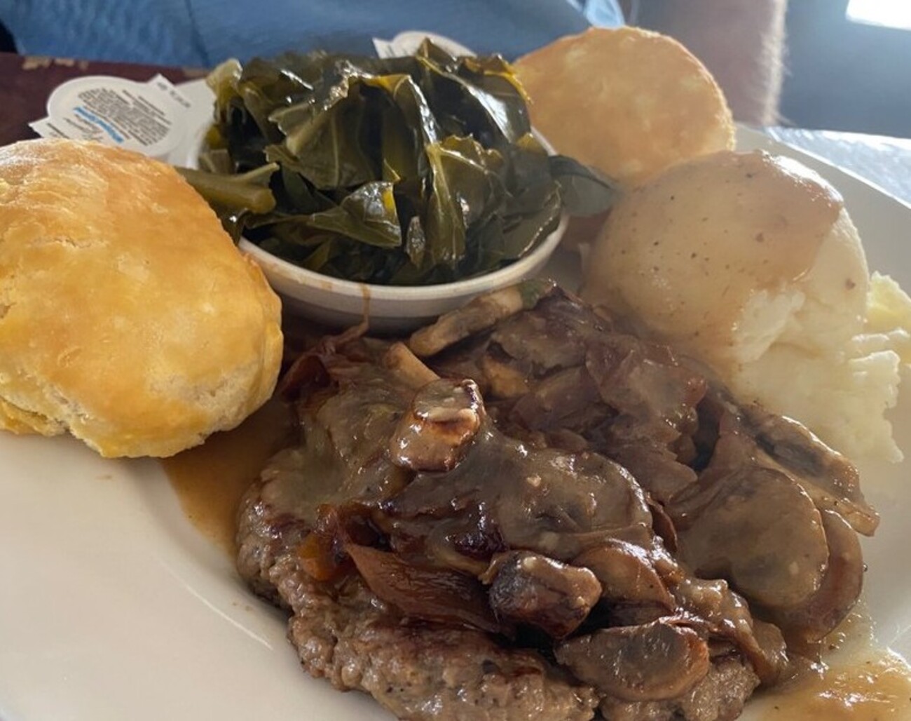 Chopped steak with mashed potatoes and collard greens at Emma's Southern Kitchen located in Knoxville, TN. 