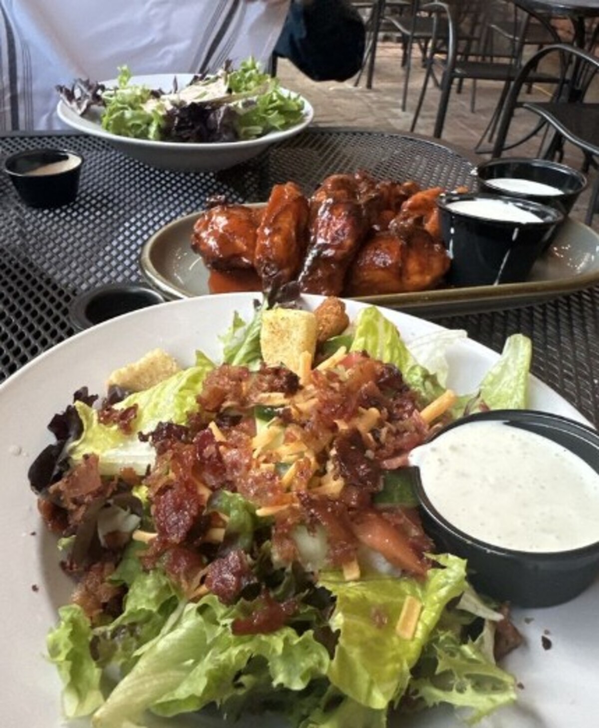 House Salad with Bacon and Steakhouse Jumbo Wings at Spotted Cow Steakhouse located in Winston-Salem, NC. 