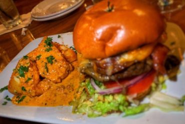 Fried Grit Cake and Harry's Burger at Harry's Seafood Bar and Grille located in Lakeland, FL.