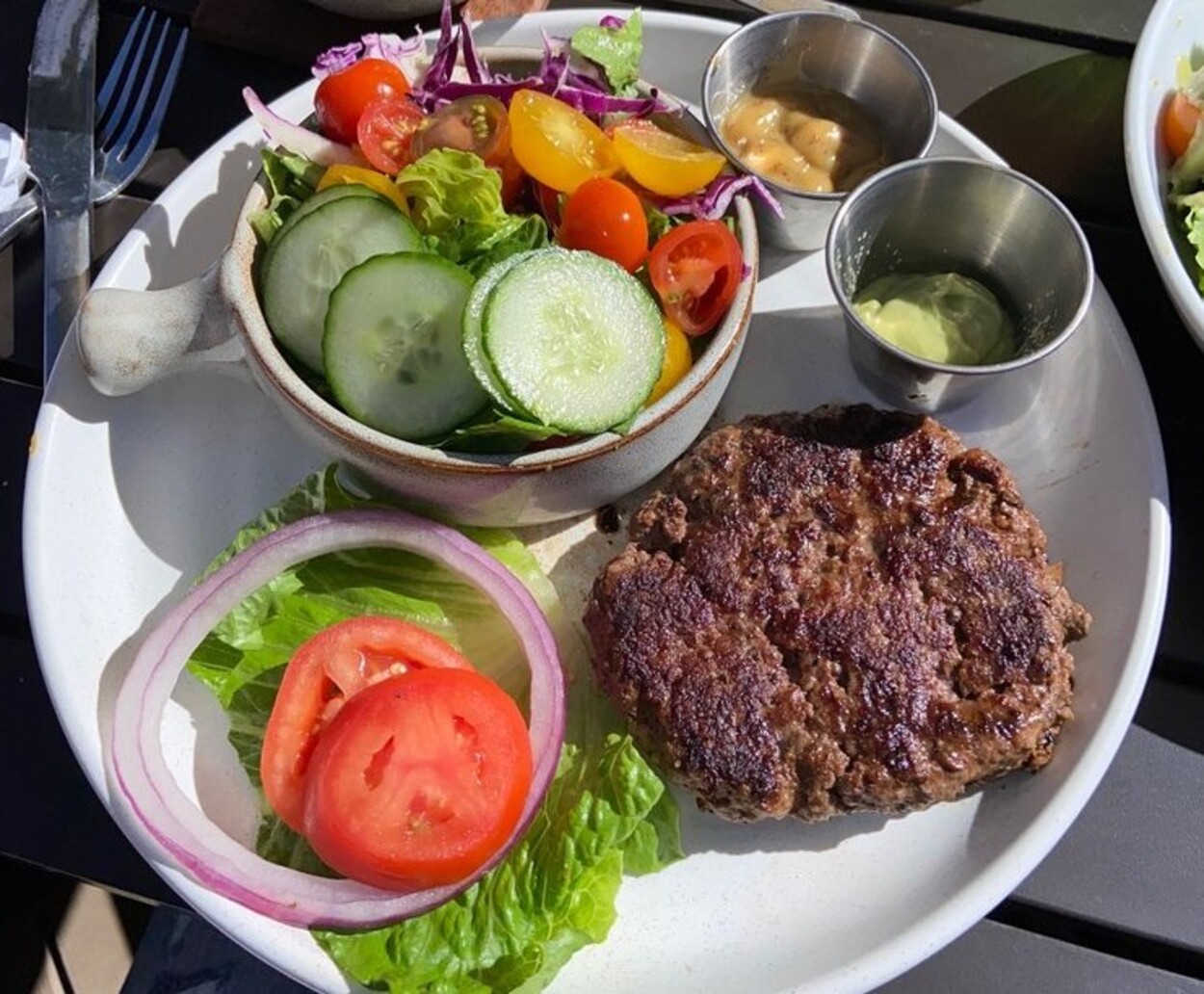 Grass fed burger sans bun with side salad at Good Kitchen + Market located in Marietta, GA.