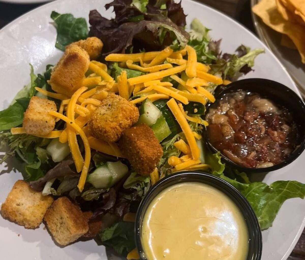 House Salad with hot bacon vinaigrette at Spotted Cow Steakhouse located in Winston-Salem, NC. 