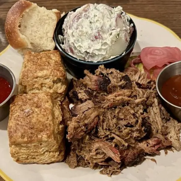 Pulled pork shoulder. Potato salad. Biscuits at Ruthie's All-Day located in Arlington, VA.