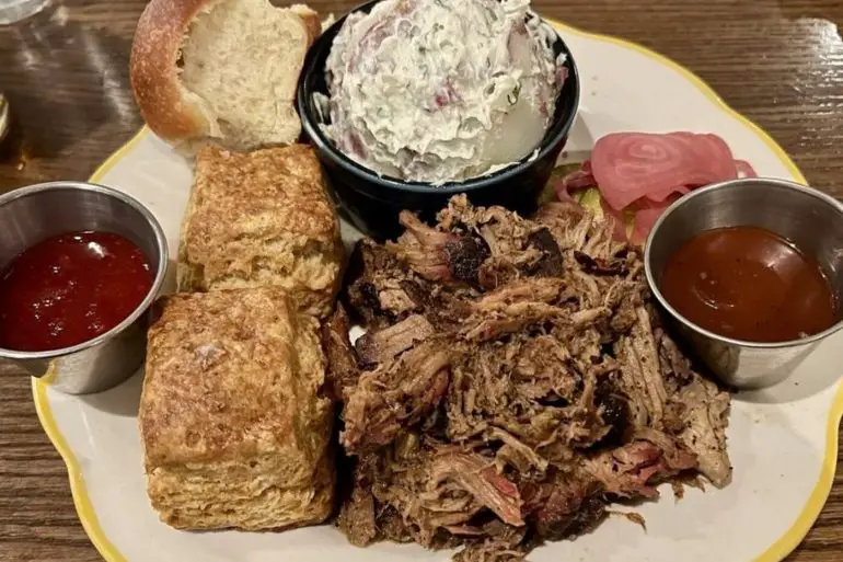 Pulled pork shoulder. Potato salad. Biscuits at Ruthie's All-Day located in Arlington, VA.