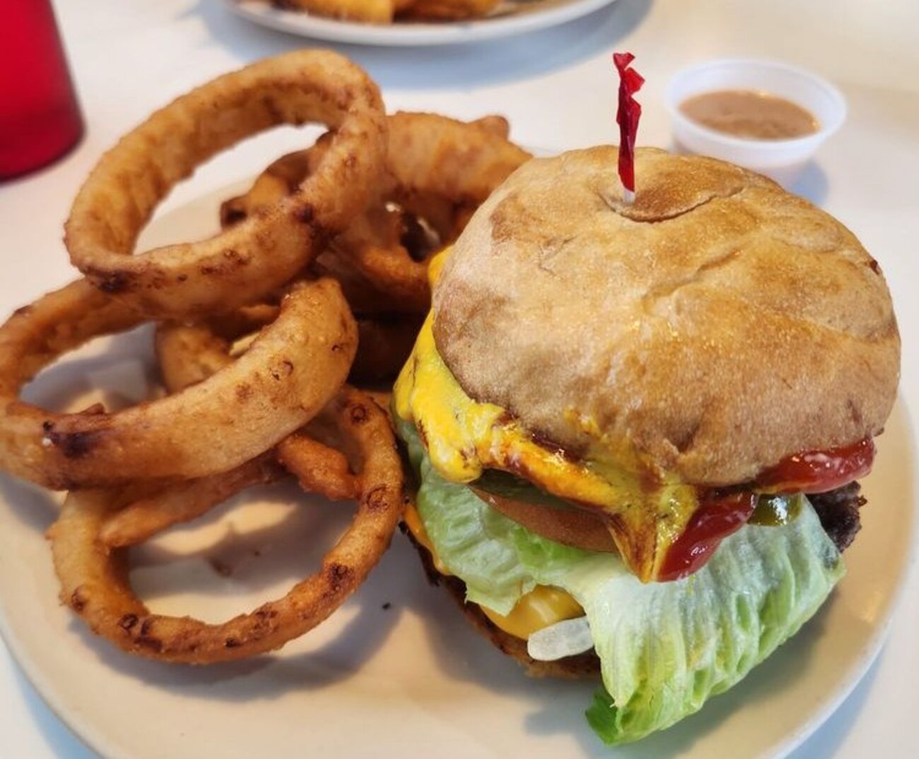 Regular cheeseburger with onion rings at Twisted Burger Diner located in Flint, MI. 