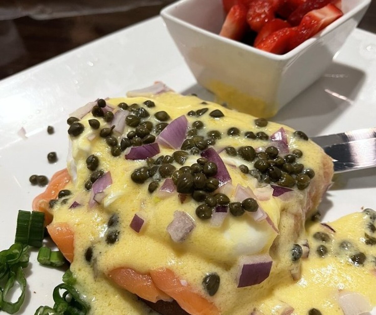 Salmon Eggs Benedict on GF Toast with Berries at Eddie's Diner located in Plano, TX.