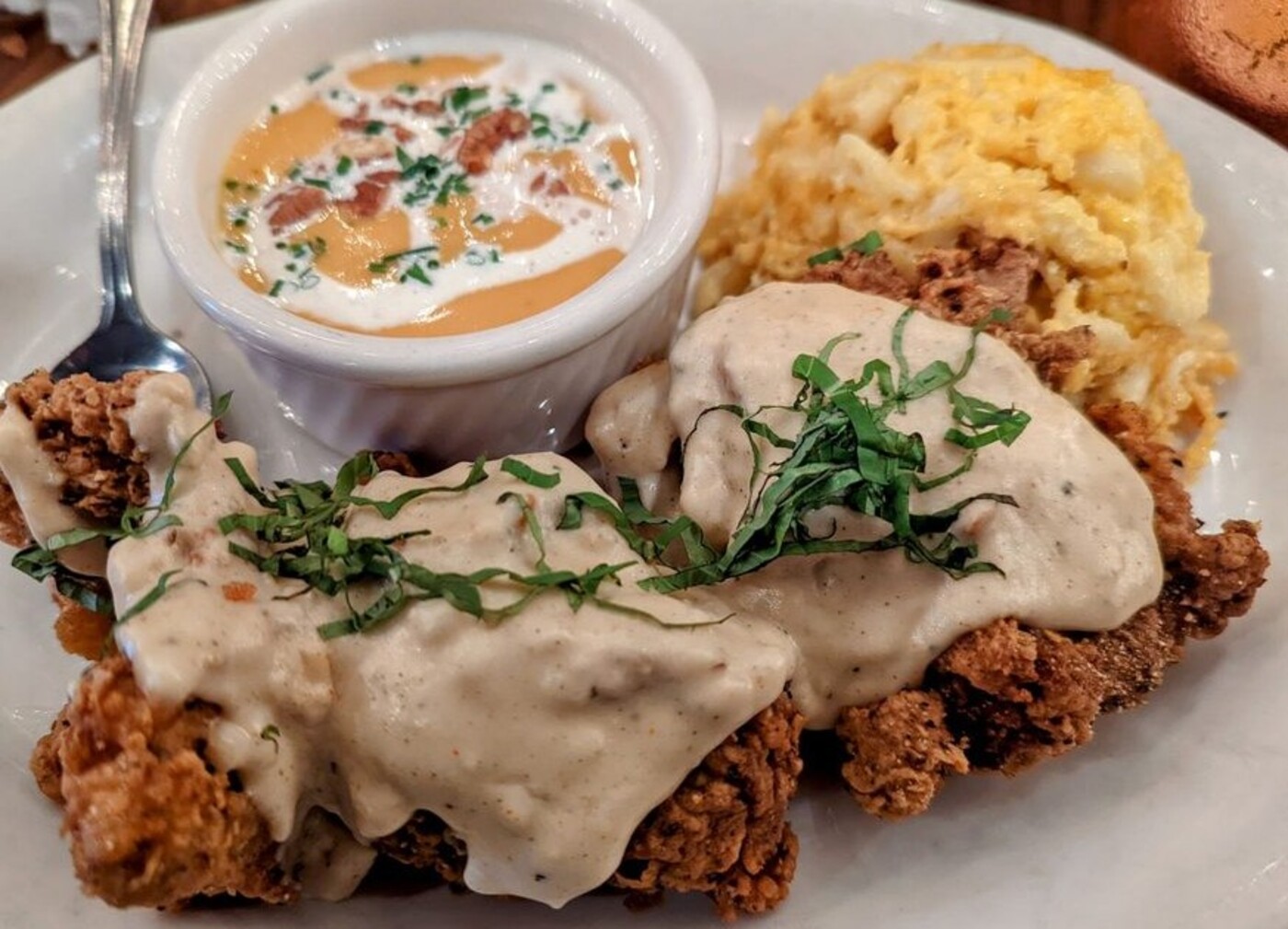 Smothered Chicken at Tupelo Honey Southern Kitchen & Bar located in Asheville, NC.