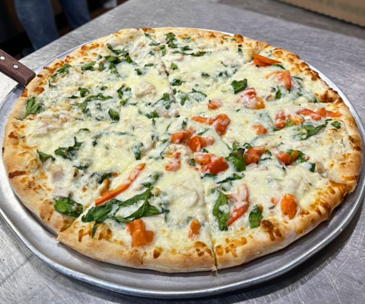White pizza with spinach and tomatoes at Italia Pizza Cafe in Southaven, Mississippi