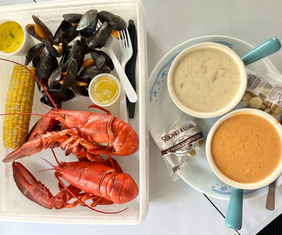 Twin lobster special, corn, steamed mussels, Seafood chowder, and lobster bisque at Alive & Kicking in Cambridge, Massachusetts