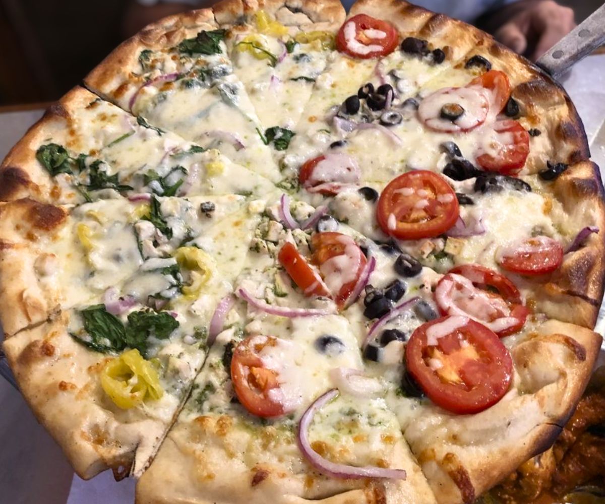 Half chicken pesto and half chicken bbq pizza at The Rail A Pizza Company in Rogers, AR