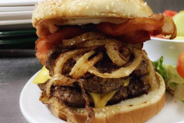 huge burger with onions at Irene's burger cafe in Palmdale, CA